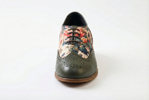 Flores is a designer elevator brogue crafted with a discreet 2.5 inch hidden lift, layered with printed floral textile panels and classic brogue construction. Designed for weddings, celebrations, statement dressing, and elevated smart casual wear, the silhouette combines handcrafted detailing with understated height enhancement and expressive texture.